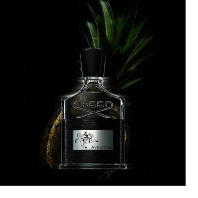 Five luxury bath and body products, including a gold hand cream tube, a black perfume bottle, two cream pump bottles, and a round cream soap bar, are displayed on a black background with golden liquid splashing around them, showing the text Creed 1760 Aventus Hand Cream Crème Mains, Creed Aventus, Creed 1760 Aventus Hand & Body Lotion Lotion Mains et Corps, Creed 1760 Aventus Hand & Body Wash Lavant Mains et Corps, and Creed 1760.